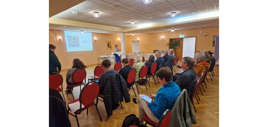 Blick auf den Saal der Veranstaltung mit Teilnehmenden